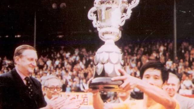 1979年，广东队队长何佳在香港捧起首届省港杯冠军奖杯。图源网络